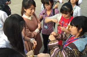 「伸ばせる飴」を初体験する日本の高校生
